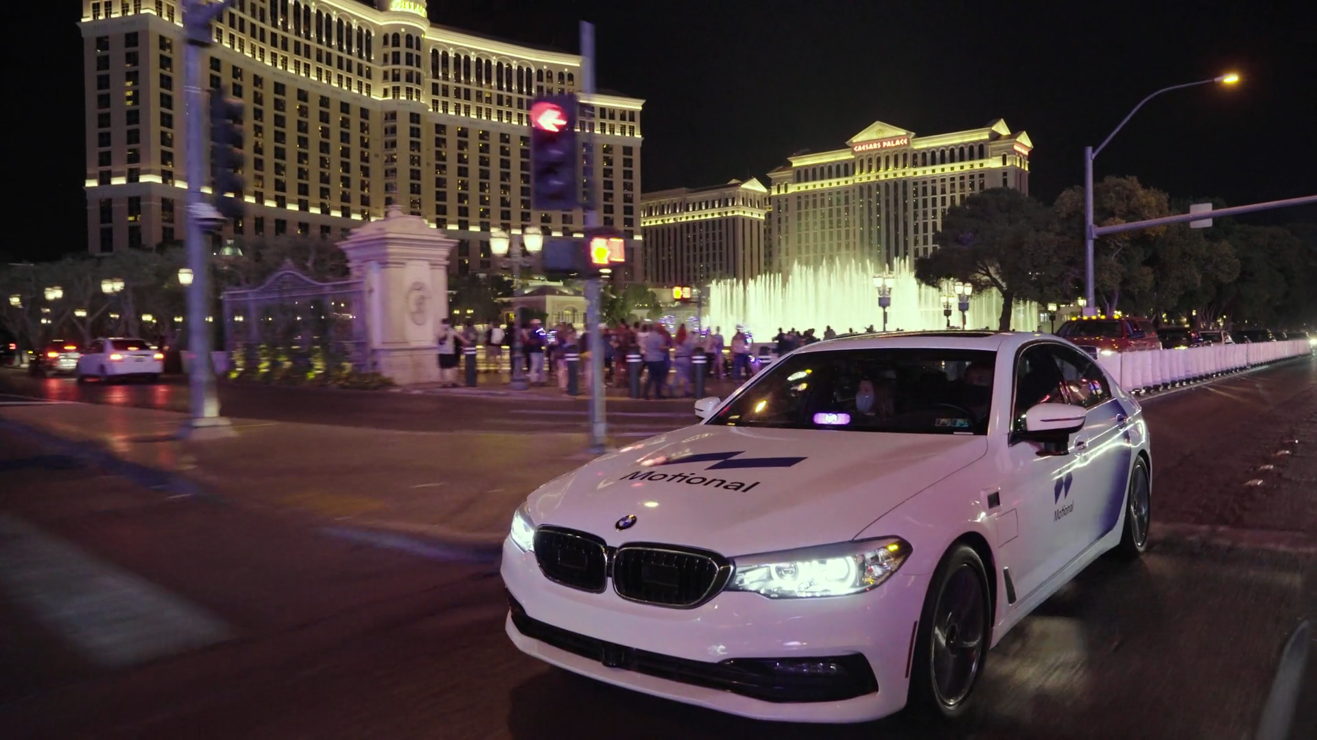 A white Motional vehicle seen in front of the Bellagio fountains in Las Vegas 