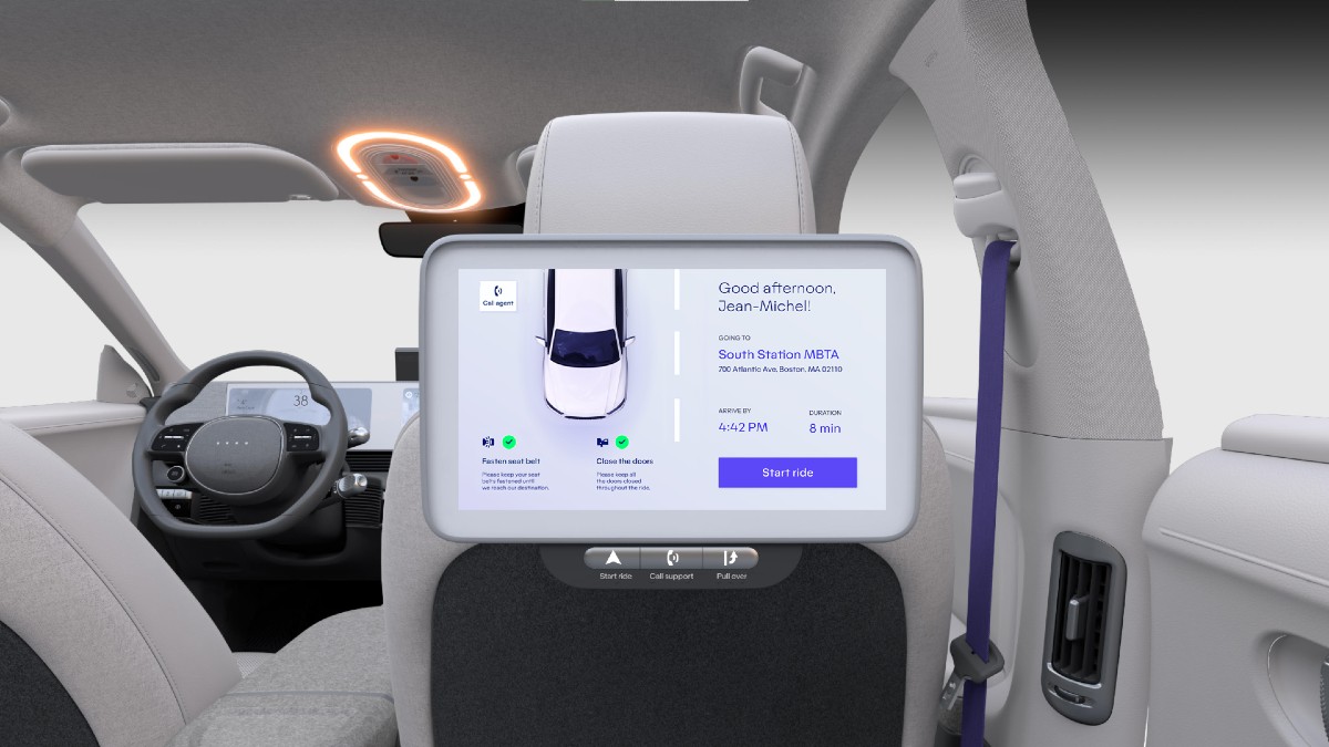 The interior of the IONIQ 5 robotaxi showing one of three passenger screens