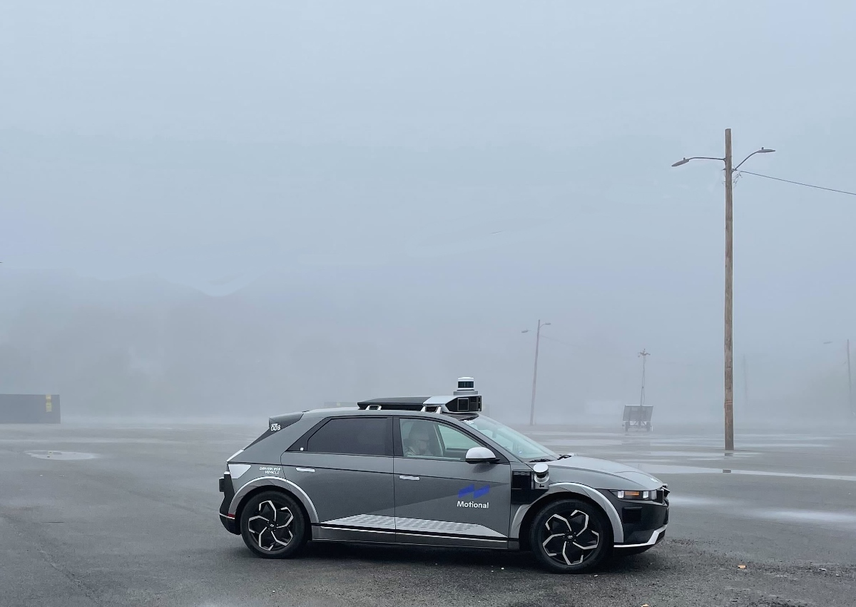 A Motional IONIQ 5 robotaxi at the East Boston testing facility on a heavily foggy day. 