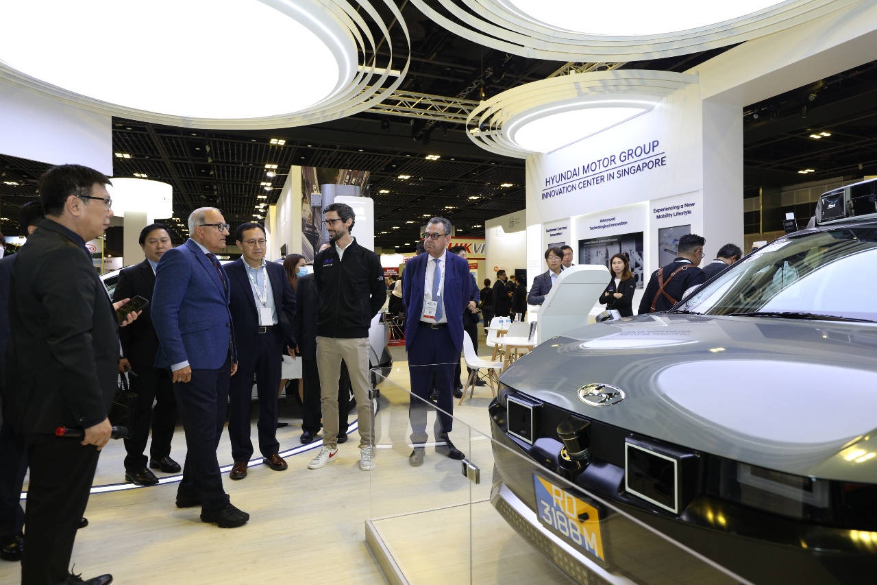 Attendees of an auto show look at the IONIQ 5 robotaxi