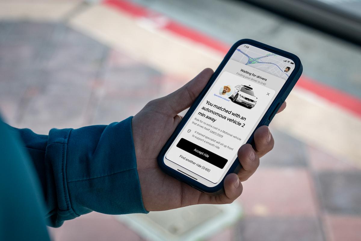 Person holding a phone with an Uber screen saying they have been matched with a Motional Robotaxi