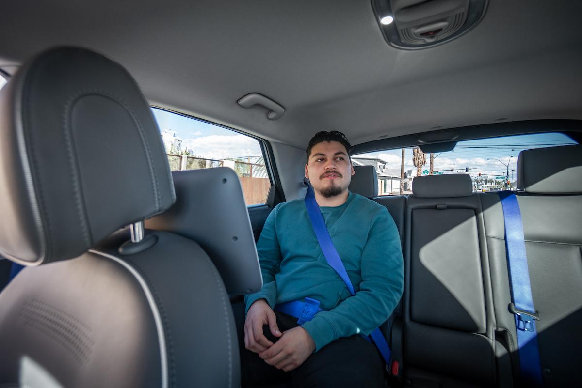 Person sitting in the back of a Motional plus Uber Robotaxi